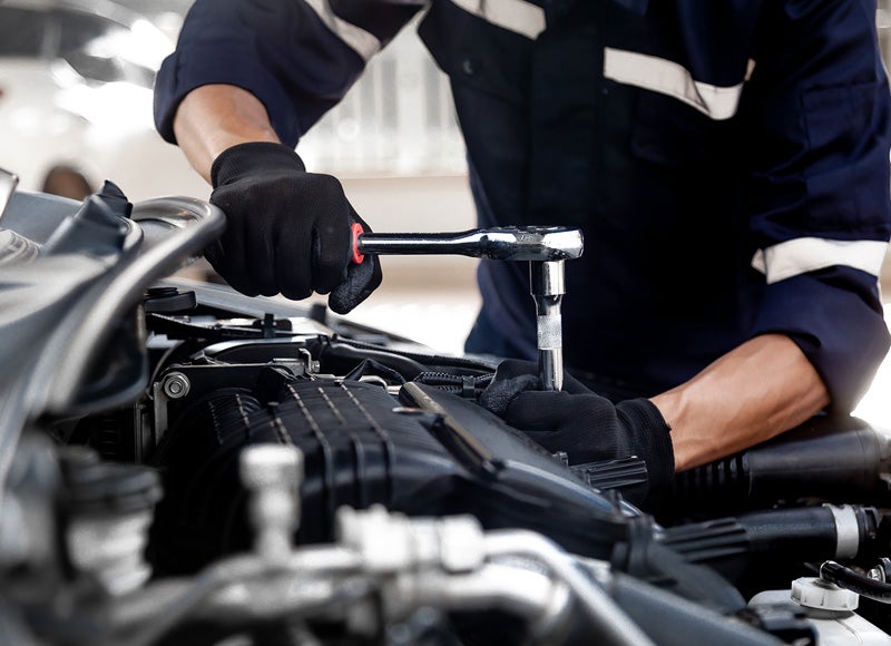 Service technician working on engine